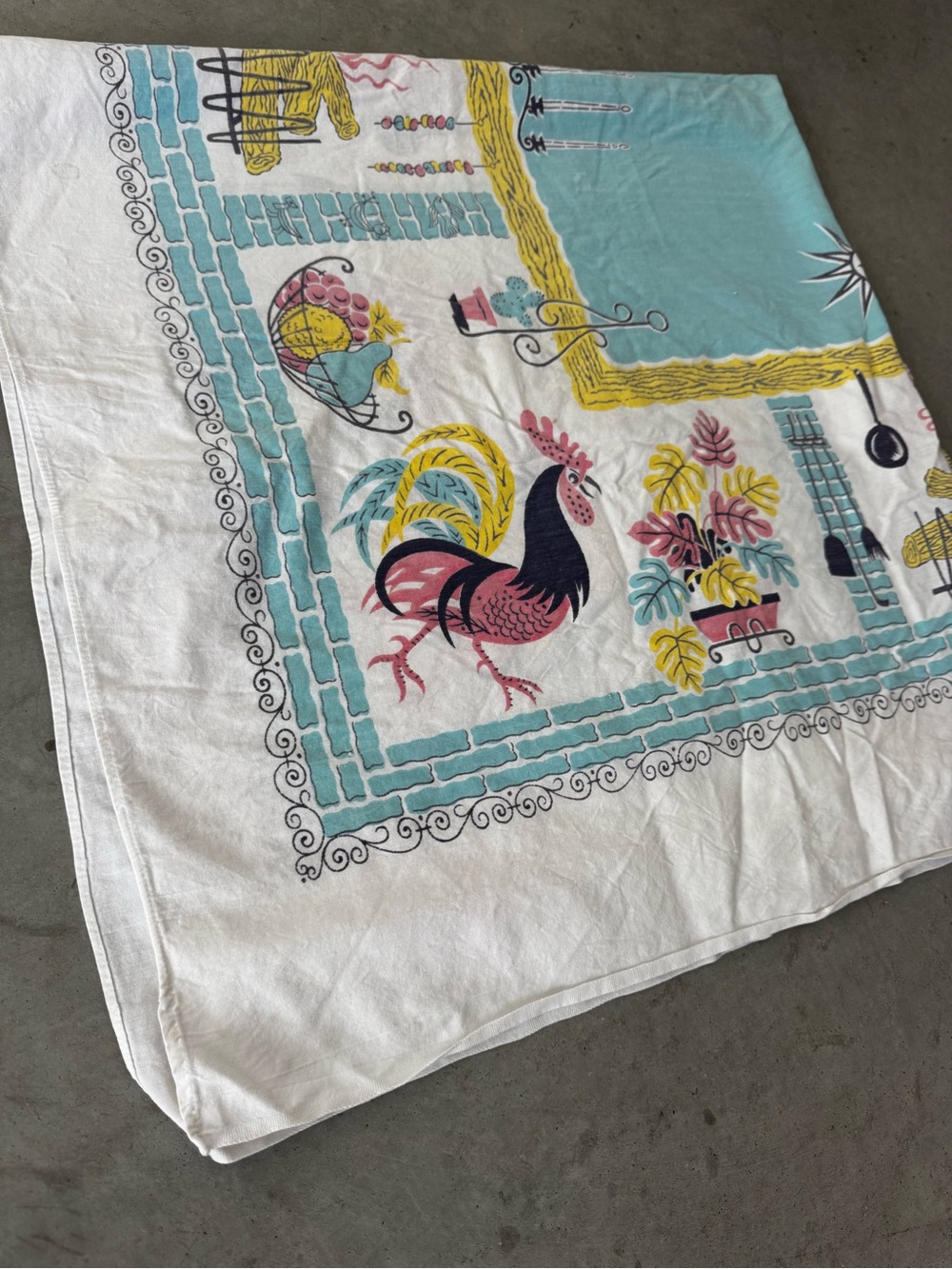Vintage charming mid-century tablecloth featuring a rooster design with border